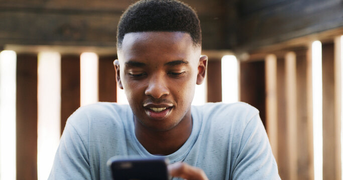 Texting, app and black man outdoor with phone, chat update and message reply on social media. Digital, reading and male person outside with tech, video streaming or entertainment browsing on internet - Powered by Adobe