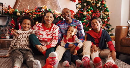 Family, laugh and portrait for Christmas, home and people on December holiday, bonding and together. Interracial, man and woman with children on Xmas, love and celebration for festive season in house