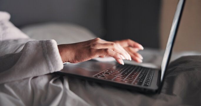 Hands, woman and laptop in bed at night for research, editing story and article submission. Person, remote work and typing on pc for headline, breaking news coverage and publication deadline at house