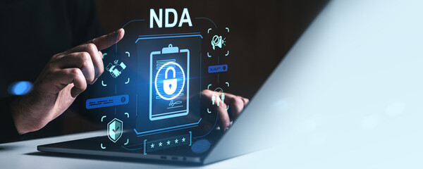 Digital concept of NDA non-disclosure agreement with lock icon and holographic interface on laptop screen representing confidentiality and data security terms.