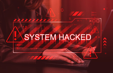 Cybersecurity breach warning with System Hacked sign overlaying person typing on laptop in red digital alert interface concept background.