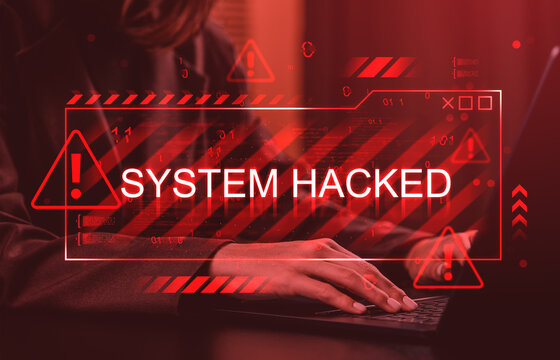 Cybersecurity breach warning with System Hacked sign overlaying person typing on laptop in red digital alert interface concept background. - Powered by Adobe