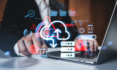 Cloud data error and cybersecurity risk concept with server icons and warning signs over business person using laptop in office setting.