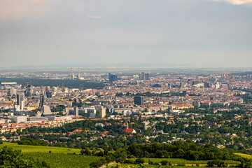 Panoramic Aerial View of European City Skyline with Green Hills and Urban Architecture