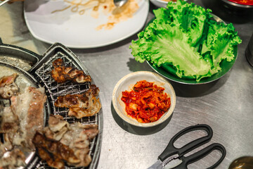 Authentic Korean Barbecue Experience with Grilled Meat, Kimchi, and Fresh Lettuce