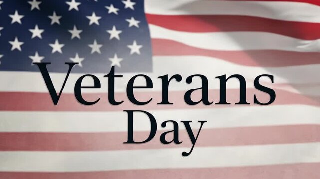 Veterans Day text overlayed on a waving American Flag, patriotism concept for veteran tribute and national holiday celebration.