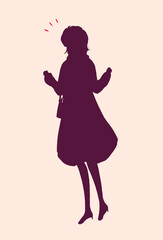 外出する女性　両手で握りこぶしを作る　冬　シルエット