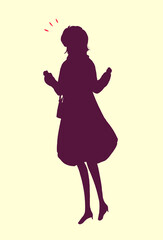 外出する女性　両手で握りこぶしを作る　冬　シルエット