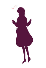 外出する女性　笑顔　両手で握りこぶしを作る　冬　シルエット