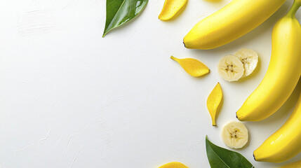 Fresh bananas arranged with leaves and slices on white background create vibrant and inviting scene