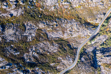 A top down aerial view of a winding road in a rocky mountain landscape The Adventure of a Scenic Drive