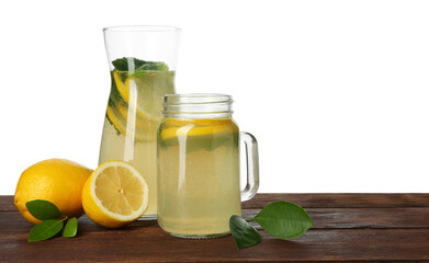 Tasty lemonade with mint and fresh fruits on wooden table against white background