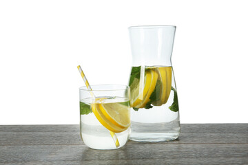 Refreshing water with lemon and mint on wooden table against white background
