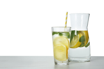 Fototapeta premium Refreshing water with lemon and mint on marble table against white background, space for text