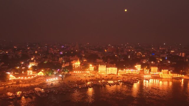 Full moon night drone footage of Assi Ghat, Varanasi glowing with boats and Ganga River reflections. A calm spiritual view of India&rsquo;s sacred night.