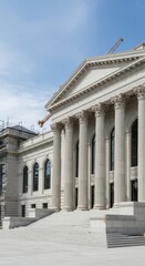 Majestic Neoclassical Government Building with Grand Columns and Steps Under a Blue Sky.