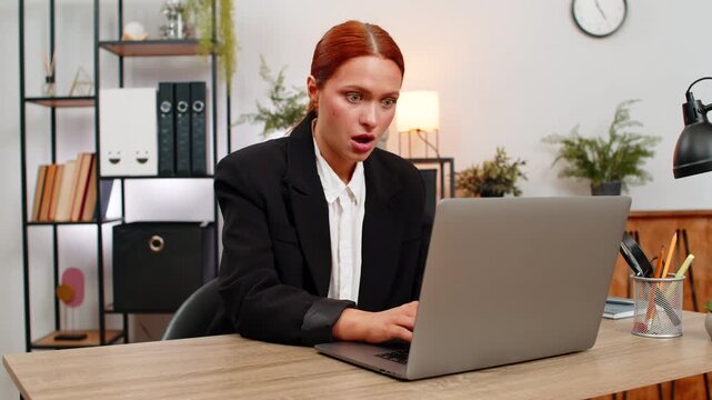 Young businesswoman at home office audits bills on laptop when wrong number appears eyes widen. Freelancer girl at table fixes digits typing correct figures feels quick relief as budget recovers again