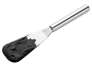 Metal palette knife spreading a black cosmetic cream on a transparent background