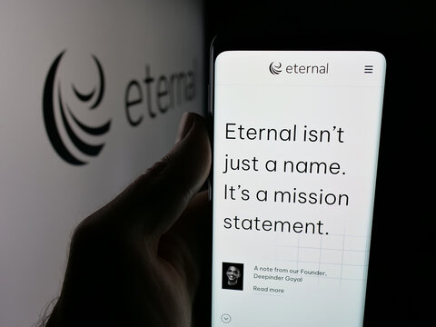 Stuttgart, Germany - 11-02-2025: Person holding cellphone with webpage of Indian technology company Eternal Limited on screen in front of logo. Focus on center of phone display.