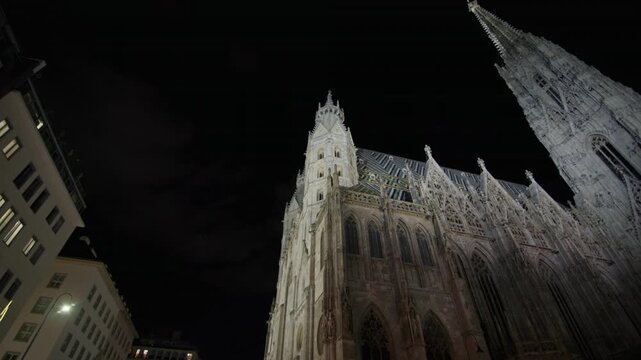 Night video of Stephens Cathedral in Vienna Austria. Gothic architecture, illuminated walls of the tourist point of Europe.