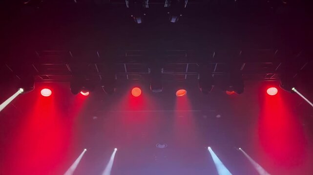 A theater stage illuminated with vibrant red spotlights. The lights create a dramatic atmosphere Stock Video