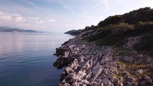 The rocky coastline of Prevlaka peninsula, Croatia, low drone shot