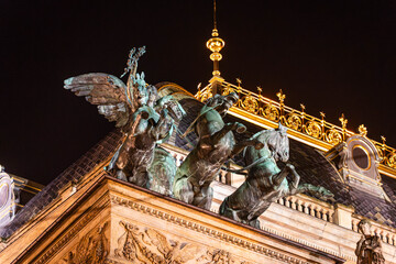 The chariot sculpture on the roof of the Rudolfinum, home of the Prague Philharmonic, brightly lit at night.