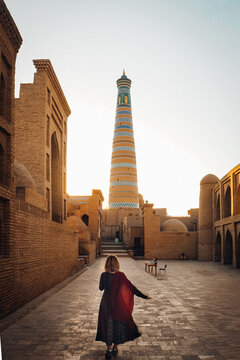 Traveler Walking Toward Kalta Minor Minaret at Sunset, Khiva Uzbekistan
