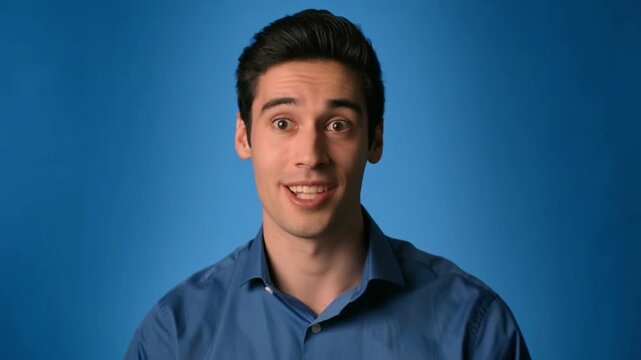 A young man with an open and friendly expression is looking at the camera, conveying a sense of approachability Stock Video