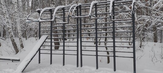An outdoor sports ground is covered in snow after a blizzard.