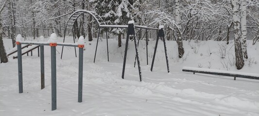 An outdoor sports ground is covered in snow after a blizzard.