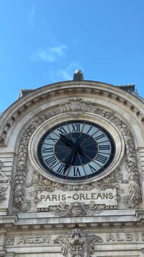 Low-angle vertical shot of Mus&eacute;e d'Orsay facade, clock face, and text.