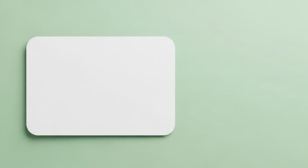 A blank white card is presented on a soft green background offering a clean space for your message