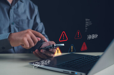 Cybersecurity concept showing person using smartphone and laptop with warning alert icons. Ideal for illustrating online security threats, data protection, or mobile cyber risk management.
