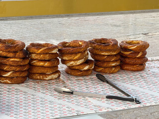 Istanbul, Turkey - August 27, 2025: Freshly baked simit bagels stacked at a street food stall in Kadikoy