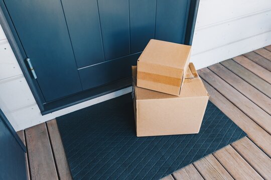 A Stacked Arrangement of Cardboard Boxes Waiting on a Doorstep, Showcasing the Convenience of Home Deliveries for Everyday Items and Gifts