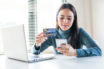 woman makes a purchase on the Internet on the smart phone with credit card, online payment, shopping online, e-commerce, internet banking, spending money