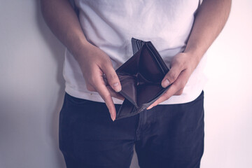 poor man hand open empty wallet looking for money ,broke ,bankrupt concept