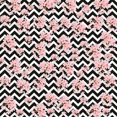 Pink cherry blossoms scattered across a black and white chevron pattern pink flowers