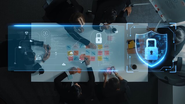 A diverse group of professionals collaborates around a modern table, utilizing technology to discuss data protection strategies, with a digital lock symbol highlighting cybersecurity. Raster - Powered by Adobe