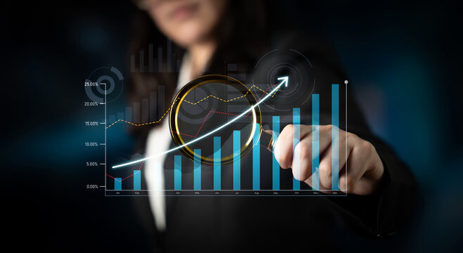 A businesswoman examines growth data using advanced digital tools in an office environment, illustrating the importance of analytics and strategy in decision-making. Scalp