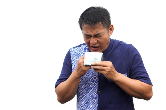 An Asian man sneezing into a handkerchief, demonstrating proper hygiene and illness prevention. Concept for flu season, cold symptoms, allergy, and healthcare awareness on white background. - Powered by Adobe