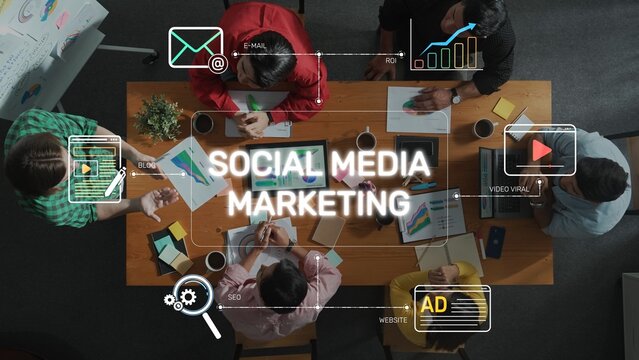 A diverse group of professionals engaged in social media marketing strategies, collaborating around a table filled with digital tools and analytics in a modern office space. Raster