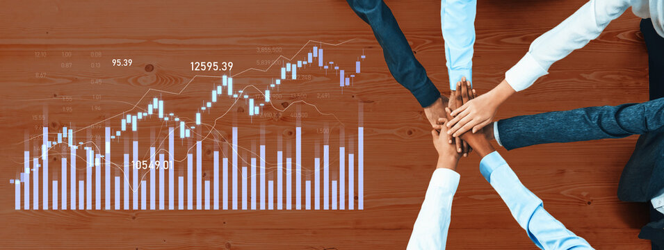 A diverse team of professionals joins hands over a financial graph representing stock market data, emphasizing collaboration, strategy, and data-driven decision-making. Scalp - Powered by Adobe