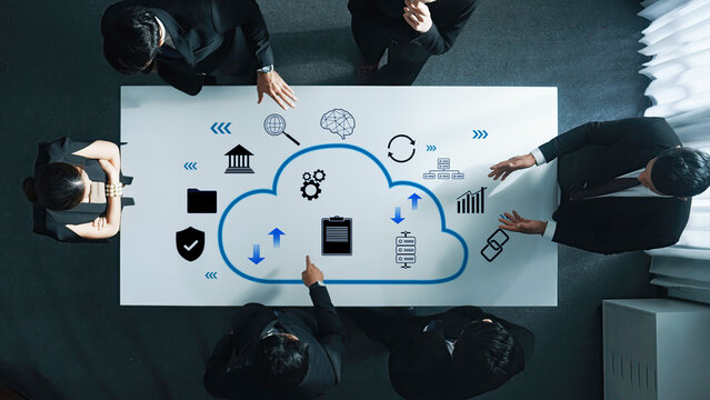 A focused team engaging in a collaborative meeting around a conference table, exploring cloud computing solutions and digital strategies for business development. Trope