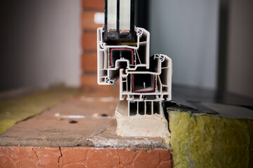 Closeup of window assembly components, Macro view of window frame with insulation and gasket, Technical study of window profile and energy efficient sealing methods
