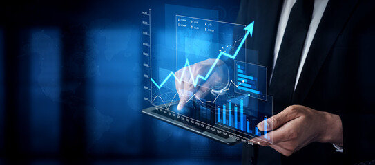 A business professional uses a digital tablet to explore data trends, with overlay graphics showing growth and success in a sophisticated corporate environment. Scalp