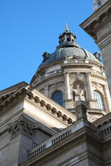 Historic European cathedral dome with classical architecture and blue sky