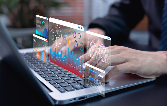 AI data science and business analytics concept, businessman using laptop to analyze financial charts and graphs for investment insights, workflow optimization, and strategic growth planning.