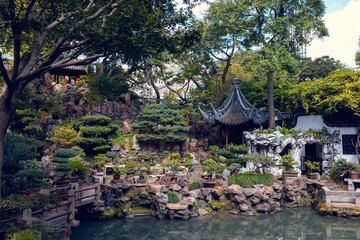 Traditional Chinese Garden with Rockery, Pavilion, and Bonsai by the Water